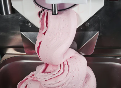 Ice cream being prepared around kitchen table